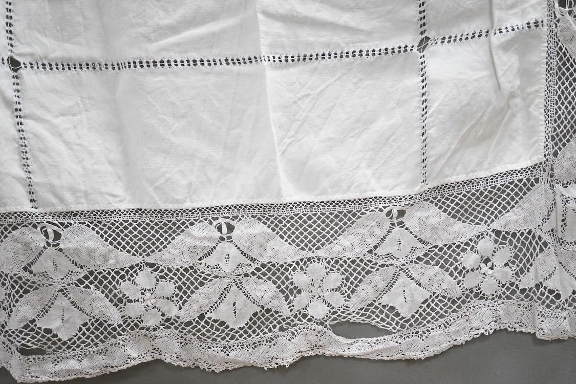 Two boxes of mixed white on white embroidered linen and cotton table cloths etc, some with crochet edging and cut work.
